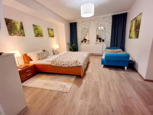a bedroom with two beds and a blue chair at 2 Rooms Family Apartment Tauchen in Mönichkirchen