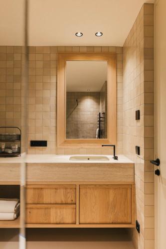 a bathroom with a sink and a mirror at Apartment Garden Loggia in Novacella