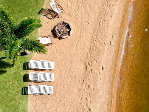an overhead view of a beach with three cars at Villa Colosseum in Florianópolis