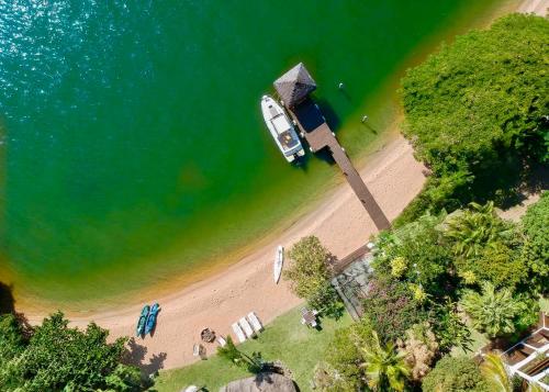 an overhead view of a beach with a boat in the water at Villa Colosseum in Florianópolis