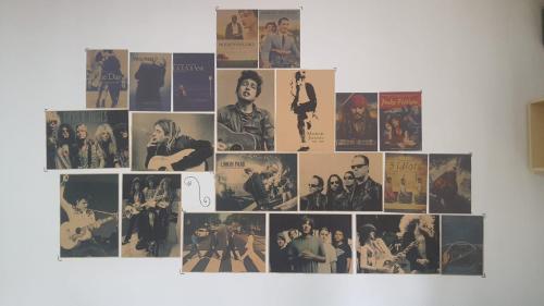 a collage of photos on a wall at Oneone eleven hostel in Belgrade