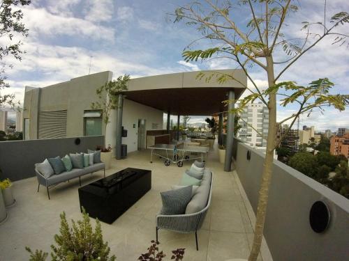 a patio with couches and a table on a building at Soneto 603 in Guadalajara