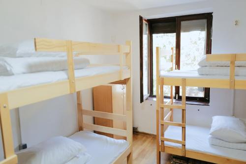 a room with four bunk beds and a window at Oneone eleven hostel in Belgrade