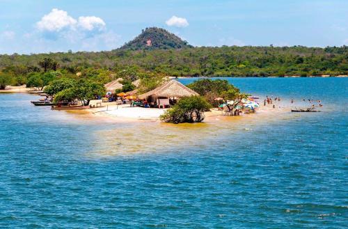 a group of people on a beach in the water at Casa Pé na Areia in Santarém