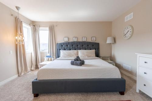 a bedroom with a large bed with a stuffed animal on it at Inspired Stay close to Niagara *4B & 2King Beds* in Thorold