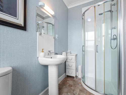a bathroom with a sink and a shower at No. 1 Charlotte Street in Port Ellen