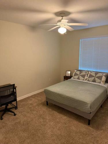 a bedroom with a bed and a ceiling fan at Great place to Relax and Shopping in Cedar Park