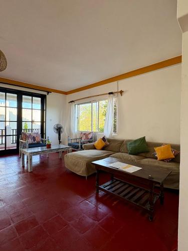a living room with a couch and a table at Wayside Beach Apartments in Diani Beach