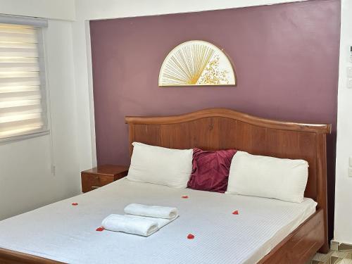 a bedroom with a bed with two towels on it at PARADISE ISLAND - Ouidah in Ouidah