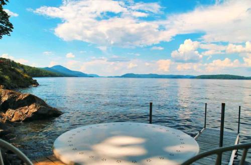a boat on a body of water at Luxury Lake Memphremagog Loft - 2 Bedrooms Water Views Firepit & Dock near Jay Peak in Newport Center