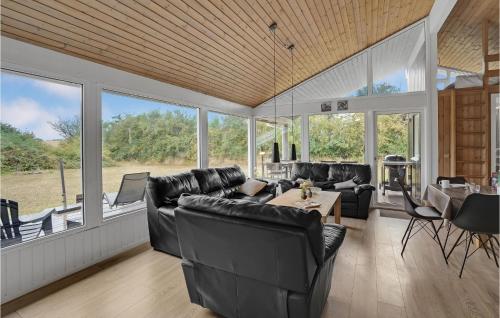 a living room with black leather furniture and windows at Nice Home In Sydals With Wifi in Høruphav