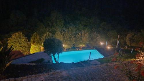 a swimming pool lit up at night at Quinta do ribeiro in Arcos de Valdevez