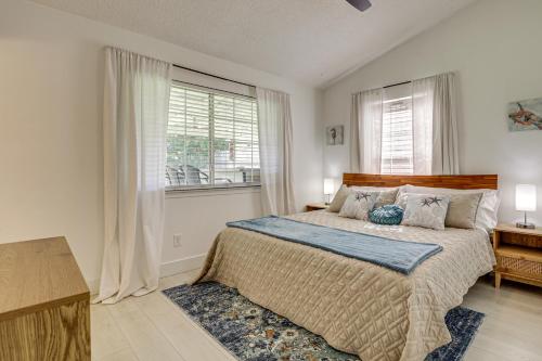 a bedroom with a large bed and a window at Less Than 1 Mi to Butler Beach! Home with Backyard Oasis in Butler Beach