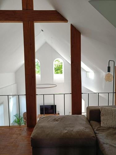 a living room with a couch and some windows at De Steeg in Kalmthout
