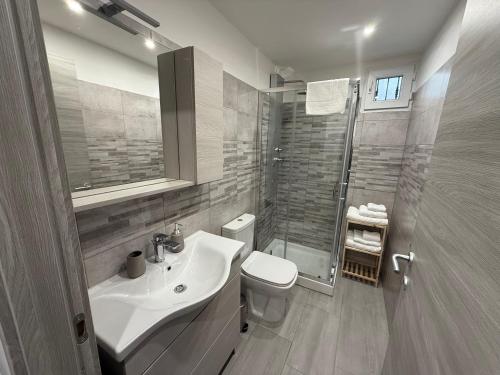 a bathroom with a sink and a toilet and a shower at DM Rooms in Catania
