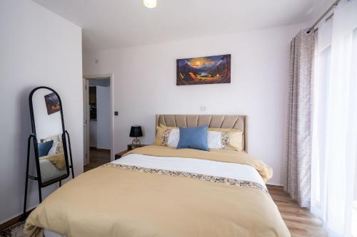 a bedroom with a large bed and a window at BethelHomes in Tatu City