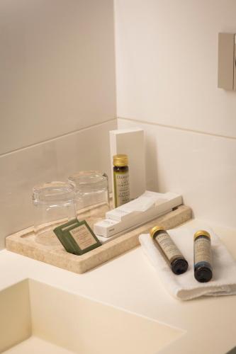 a white counter with a wooden tray with products on it at Hotel Masía Bellver in Benicàssim