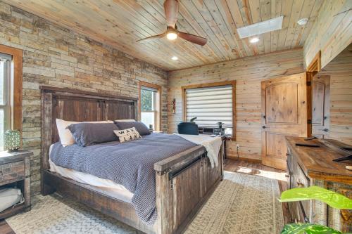 ein Schlafzimmer mit einem Bett und einer Holzwand in der Unterkunft Upscale A-Frame Escape with Lake Access in Quinton! in Carlton Landing