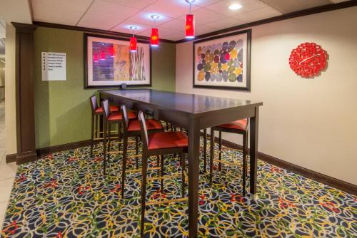 a dining room with a table and chairs at Holiday Inn Express Cleveland Airport - Brook Park by IHG in Brook Park