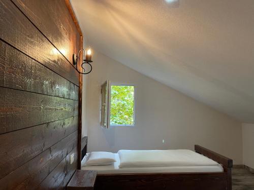 a bed in a room with a window at Hotel Hani in Peje
