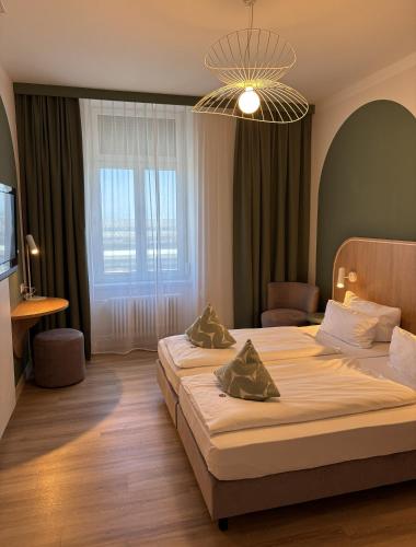 a bedroom with two beds and a large window at Gästehaus Centro in Konstanz in Konstanz