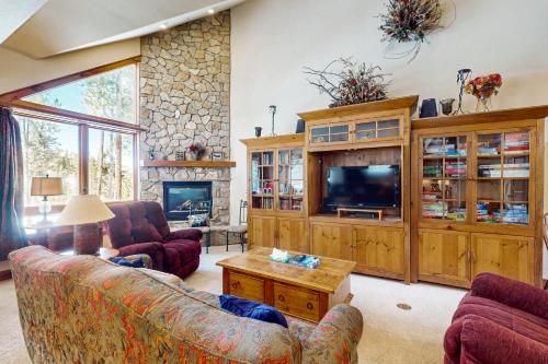 a living room with couches and a tv at Saddlewood Iliff #33 in Breckenridge