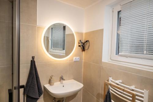 a bathroom with a sink and a mirror at Motel Kalos in Haiger