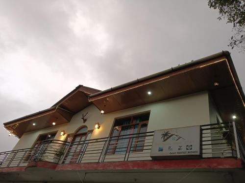 a building with a sign on the side of it at Samaira home stay in Bīr