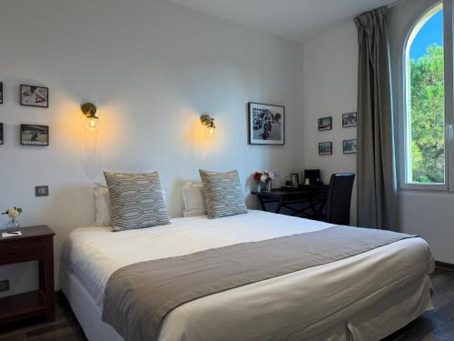 a bedroom with a large bed and a window at Ideal Sejour Cannes - Hôtel de Charme in Cannes