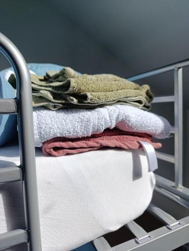 a pile of towels sitting on top of a crib at résidence KAKIKA in Verviers