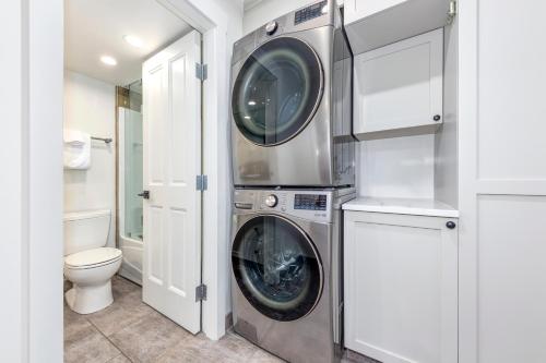 a washing machine in a bathroom with a toilet at Lake Placid Lodge 126 in Whistler