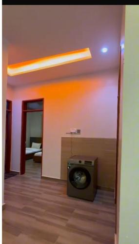 a room with a stove in the middle of a room at Petal & Palm in Buye