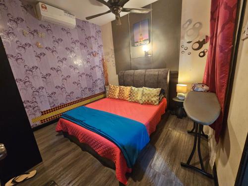 a small bedroom with a bed and a chair at The Mons inside Tower Regency Hotel and Apartments in Ipoh