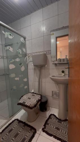 a bathroom with a sink and a toilet and a shower at Apartamento Vila Isabel in Maragogi