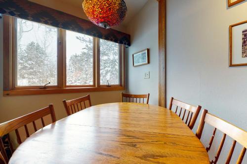 a dining room table with chairs and a chandelier at 621 Tamarack in Wilson