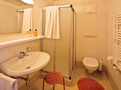 a bathroom with a sink and a shower and a toilet at Appartements Erika in Falzes