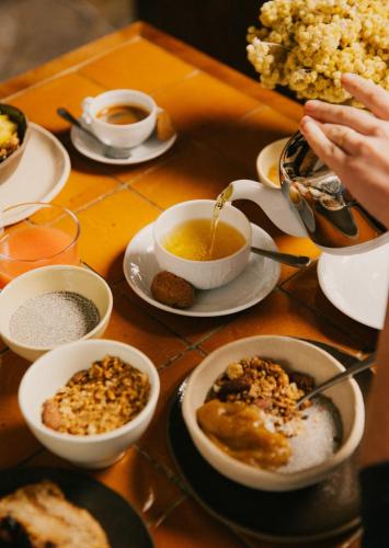 a table with bowls of food and cups of coffee at Le Moulin, Lourmarin, a Beaumier Hotel in Lourmarin