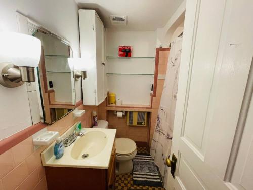 a small bathroom with a sink and a toilet at Style and Charm 2BR apt in Melrose Park in Elkins Park
