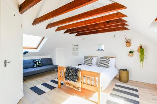 a bedroom with a bed and a blue couch at The Net Loft in Anstruther