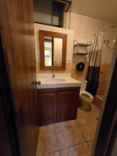 a bathroom with a sink and a toilet at Amaru Peru Hotel in Huaraz