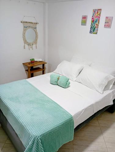 a bed with two pillows on it in a bedroom at Sweet Home in Curití