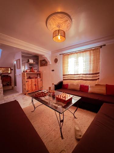 a living room with a couch and a table at Vagusta Surf House in Agadir