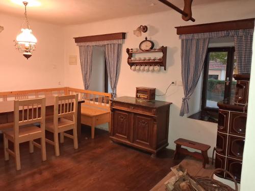 a living room with a dining room table and a dining room at Chalupa Vagner, Pernek in Horní Planá