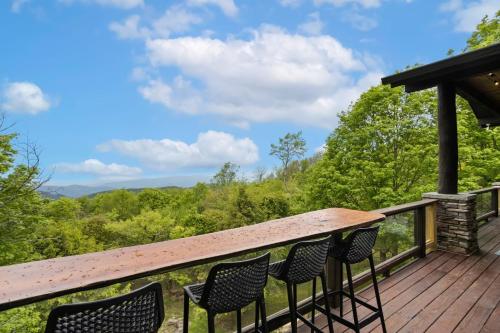 a deck with chairs and a view of the mountains at Cardinal Perch in Beech Mountain