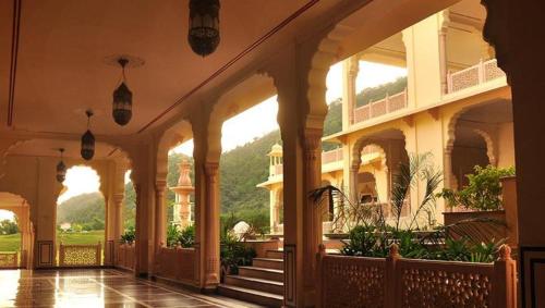 a hallway of a building with stairs and plants at Rajasthali Resort & Spa in Jaipur