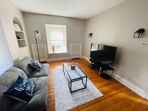 a living room with a couch and a television at Your Home Away From Home in Melrose Park