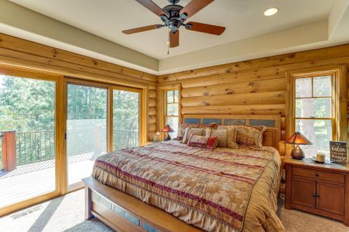 a bedroom with a bed and a balcony at Hike, Fish and More Grand Cabin with Decks in Sturgis in Crook City