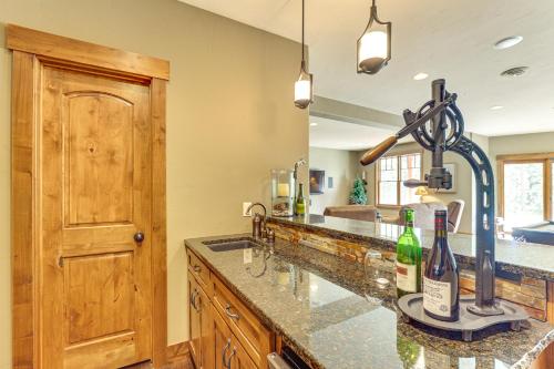 a kitchen with a counter with two bottles of wine at Hike, Fish and More Grand Cabin with Decks in Sturgis in Crook City