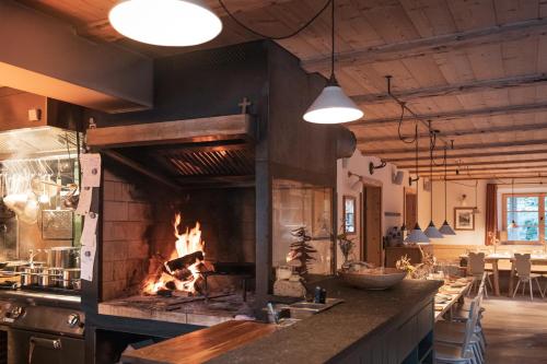 a kitchen with a large stone oven in a room at STUBN in der Frasdorfer Hütte in Frasdorf