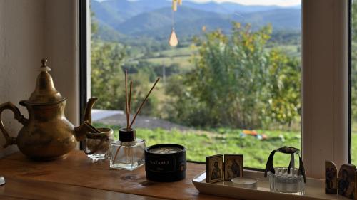 a table with a window with a view of a mountain at Mystic Twistic in Vîrfurile